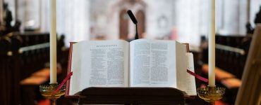selective focus photography opened Bible on book stand