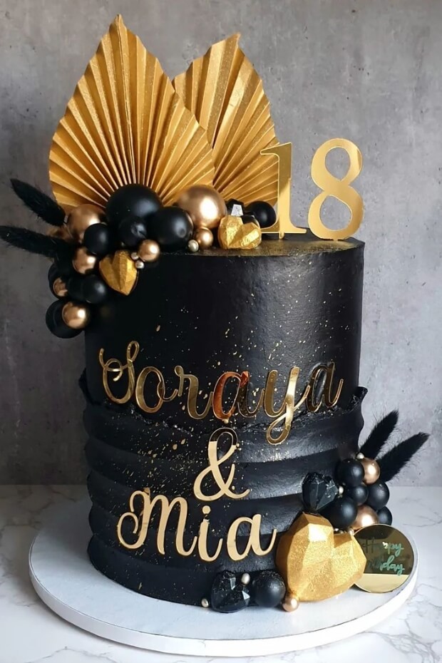 Striking black and gold wedding cake with contrasting black and gold frosting