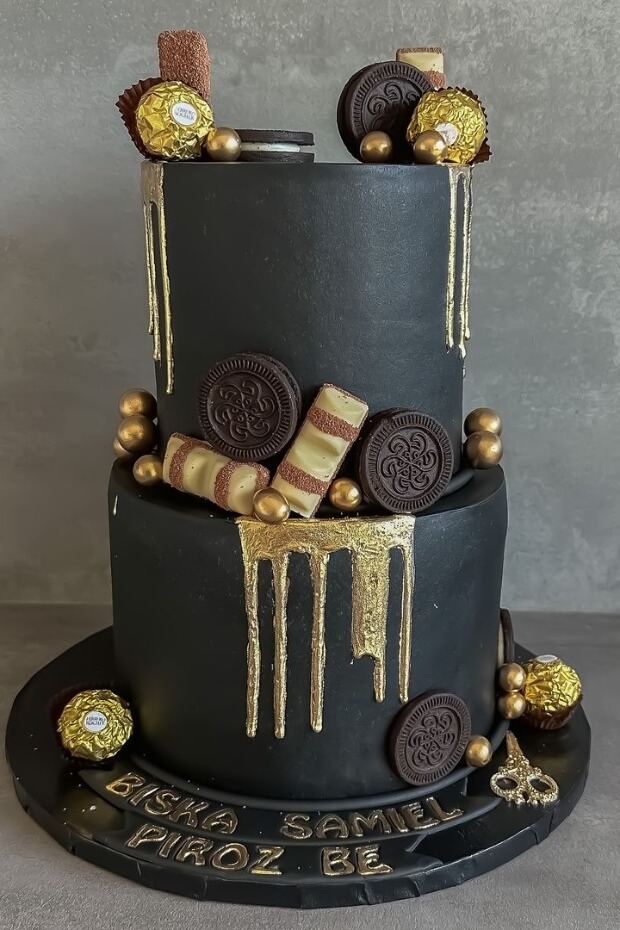 Luxurious black and gold wedding cake with chocolate ganache topping and gold leaf accents