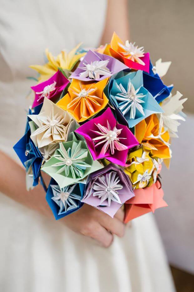 Bride holding bouquet of colorful origami flowers