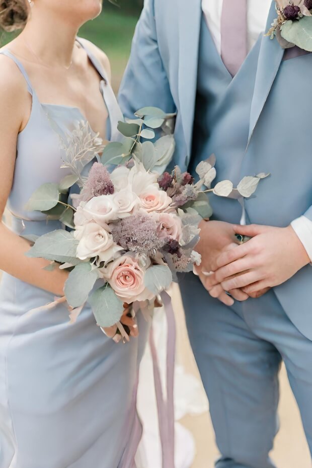Bride and Groom in Blue Suits with Mauve Wedding Attire