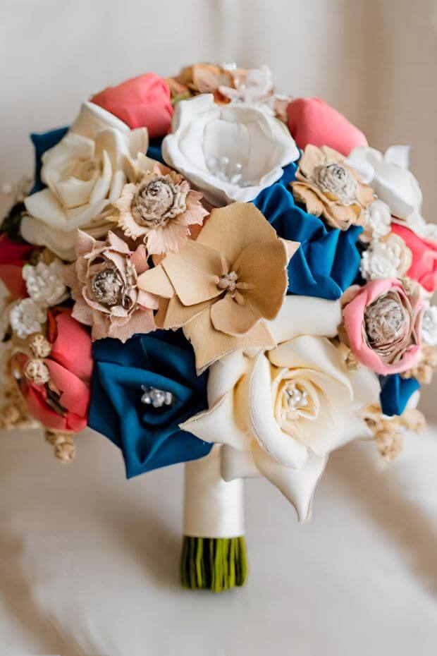 Bride holding red, white, and blue origami flower bouquet