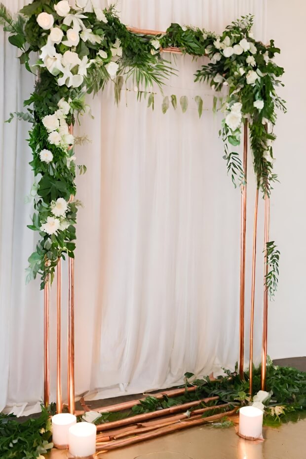 Copper arch with green foliage and white flowers