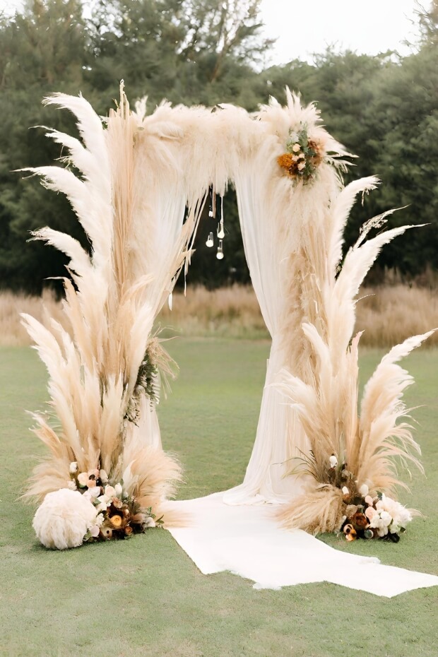 Elegant grass and feather wedding backdrop with aisle