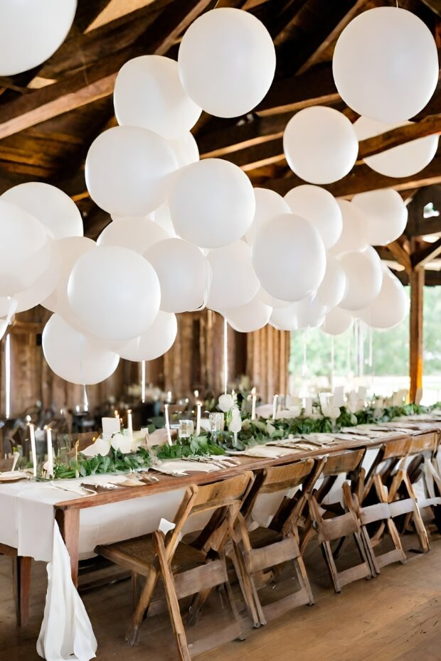 Elegant wedding setup with floating white balloons
