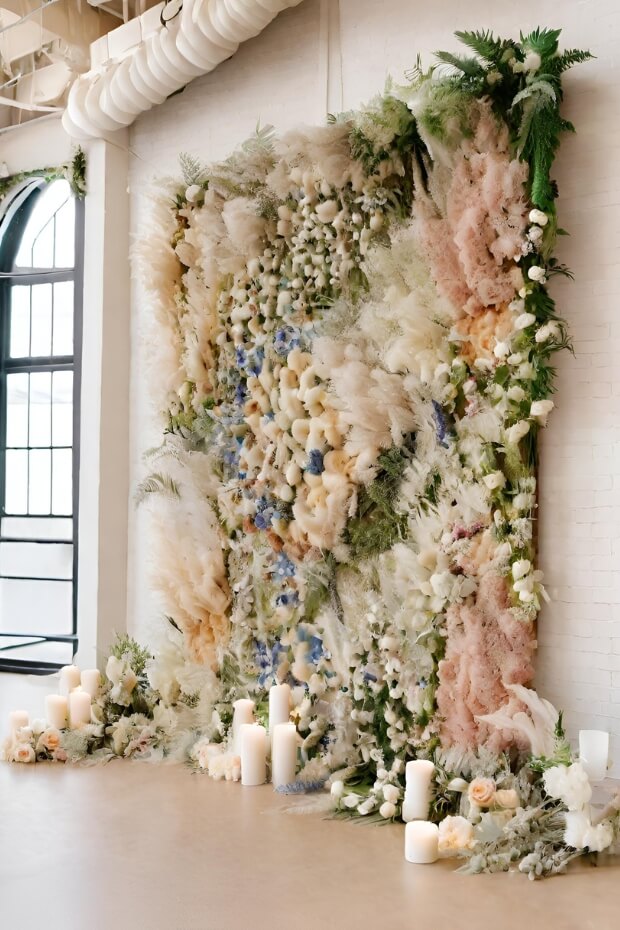 Lush greenery and colorful flower wall wedding backdrop