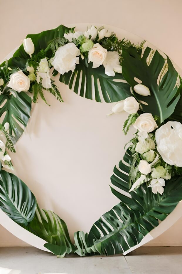 Round white and green leaf wedding backdrop with flowers