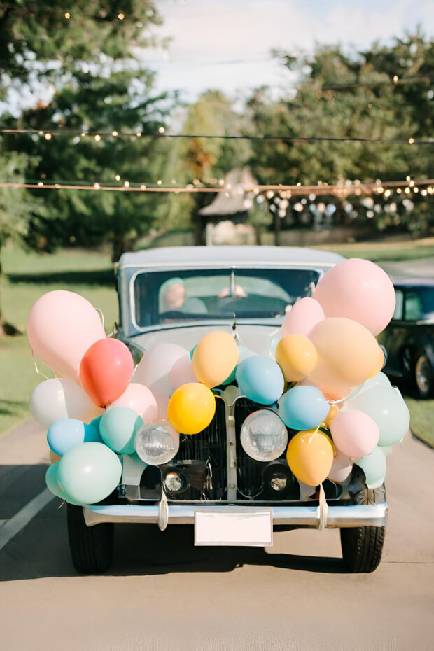 Vintage car decorated with colorful balloons