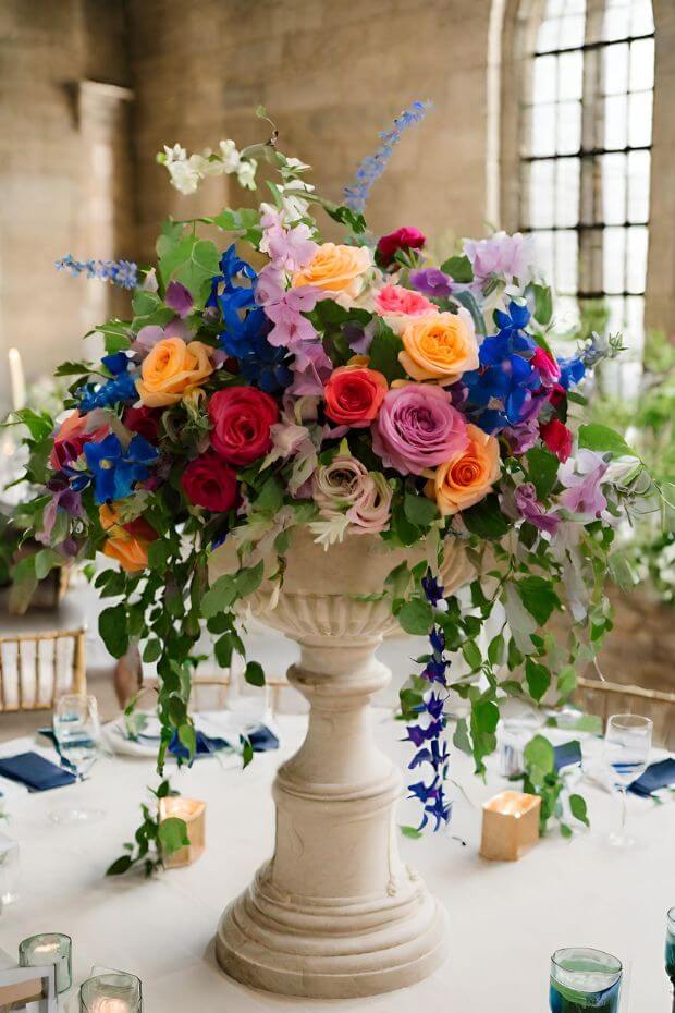 Colorful flower arrangement in vase with purple, blue, pink, and orange blooms