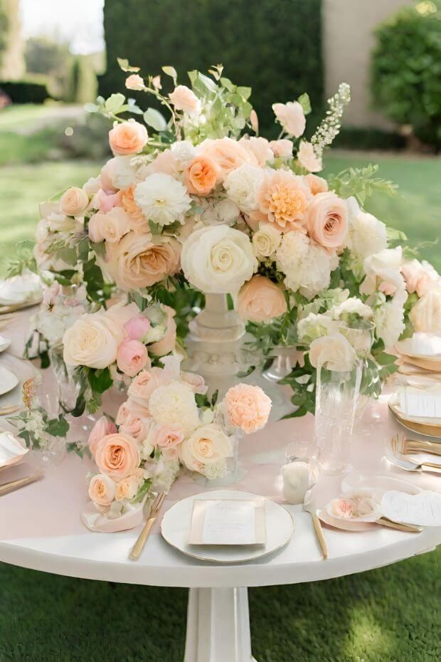 Elegant pink and white blooms centerpiece on round white table