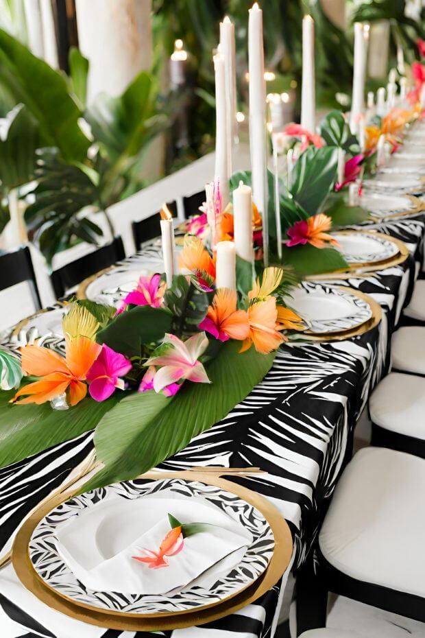 Zebra-printed tablecloth with gold and white runner, adorned with colorful flower centerpiece