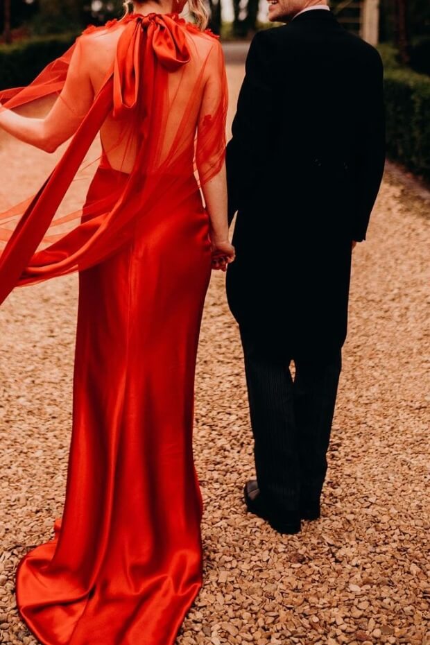 Couple walking down pathway in elegant attire