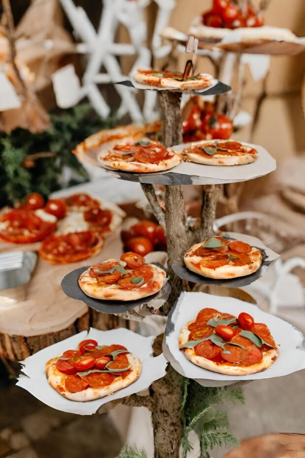 Creative display of pizzas on wooden stand