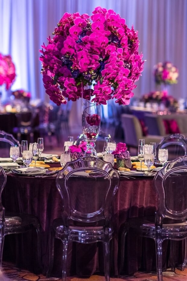 Elegant dining setup with purple flower centerpiece