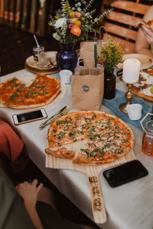 Group enjoying pizza around dining table