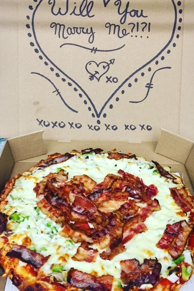 Heart-shaped pizza box with toppings