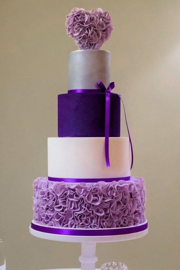 Purple wedding cake with striped and ruffled tiers