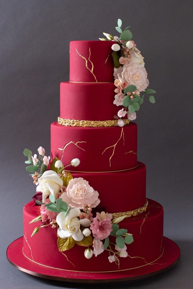 Six-tiered red wedding cake with gold border