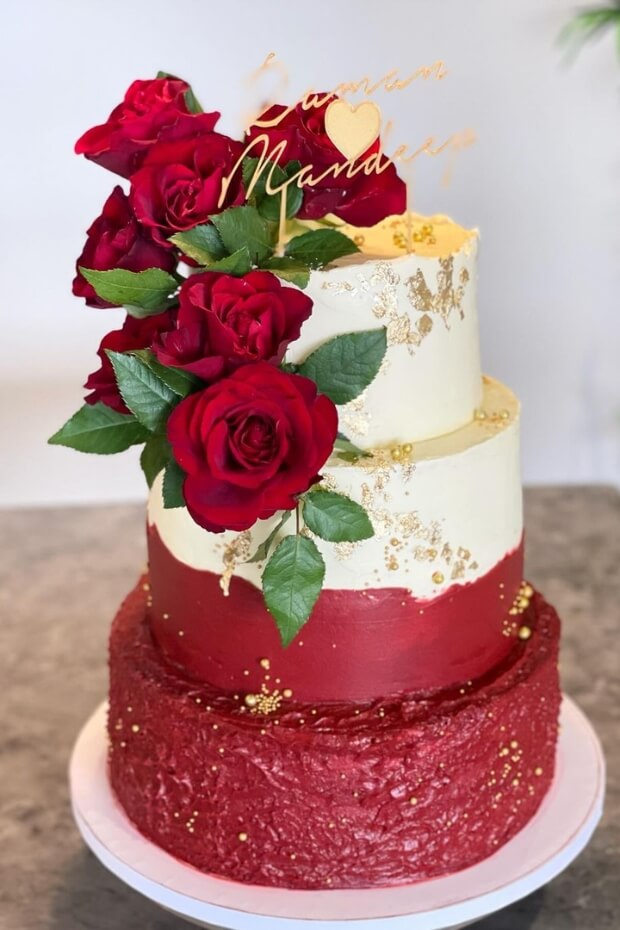 Stunning three-tiered wedding cake with red rose