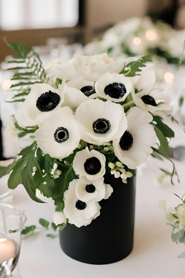 White and black flower arrangement with ferns