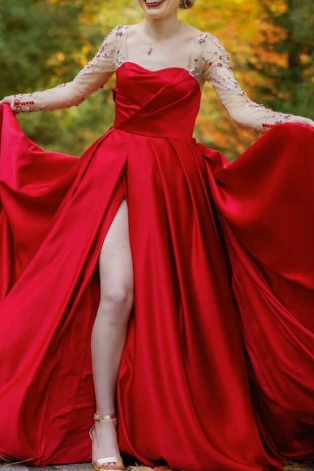 Woman in red dress standing in forest