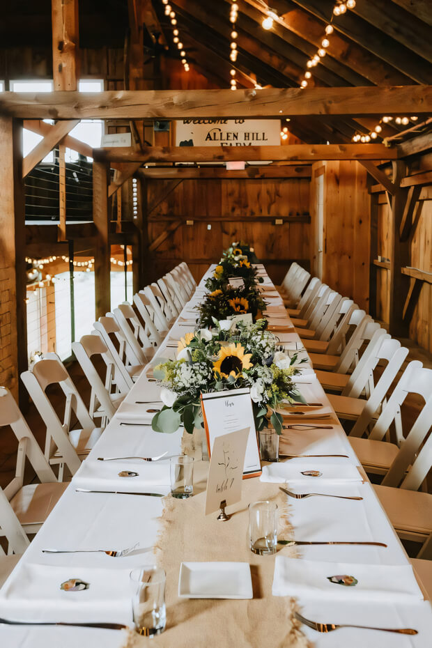 Rustic barn wedding table with burlap runner