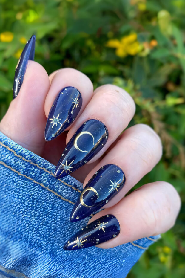 Celestial nail art on midnight blue base coat