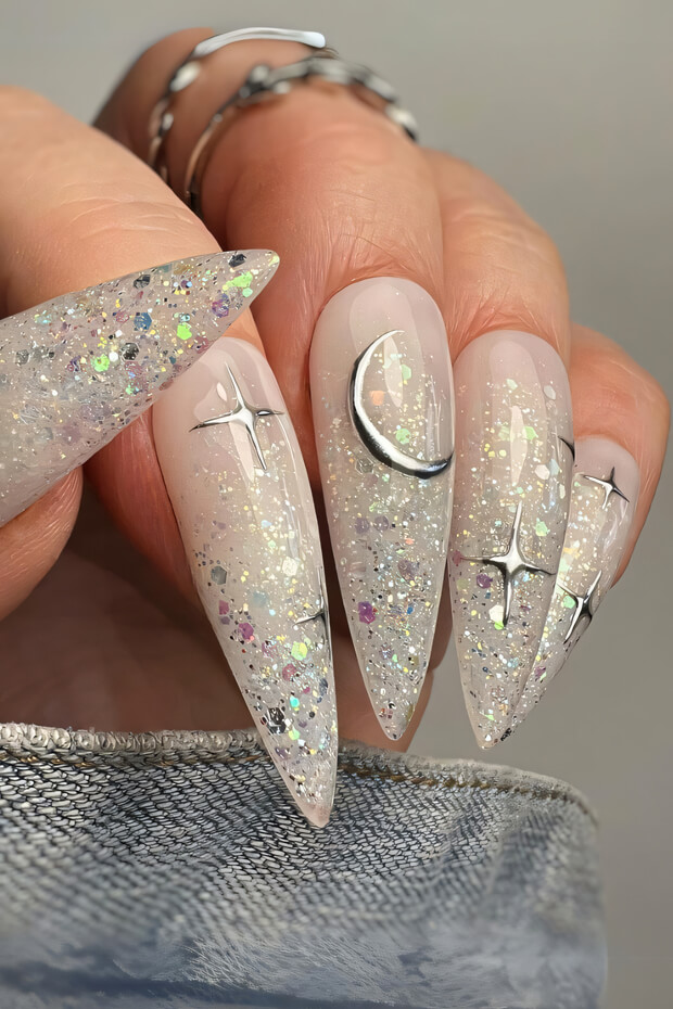 White stiletto nails with celestial glitter and stars