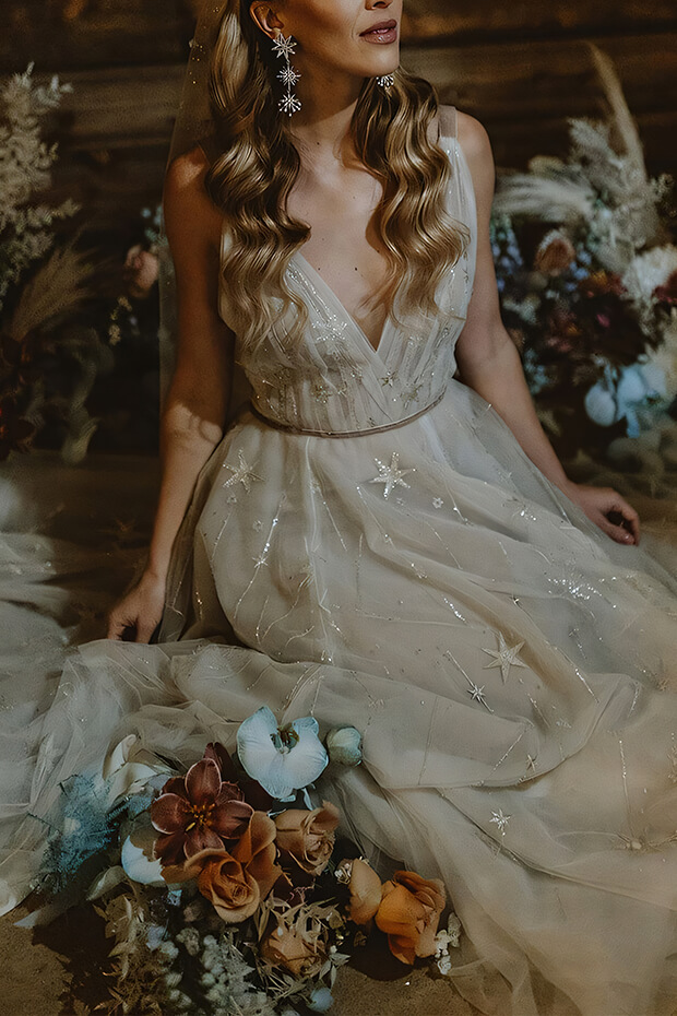 Bride in v-neck wedding gown with star embroidery