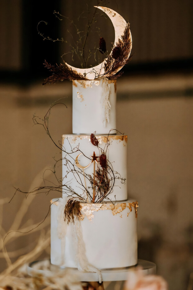 Stunning wedding cake with crescent moon and twigs