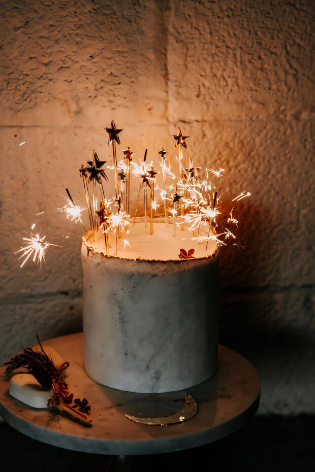 Wedding cake adorned with sparklers and celestial theme