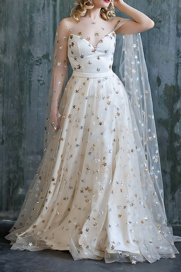 Bride in white gown with gold stars and flowing veil