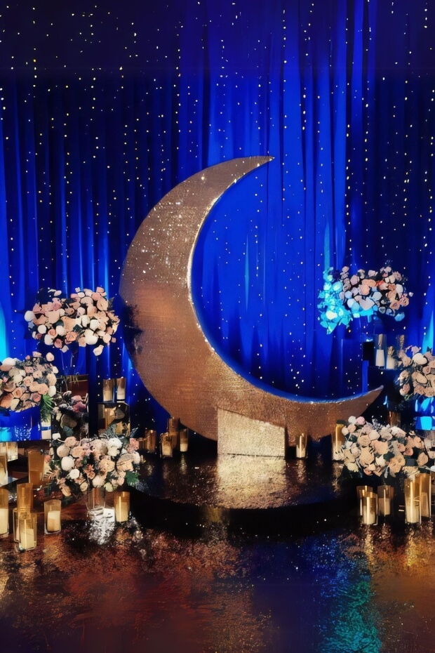 Large crescent moon surrounded by florals and lights