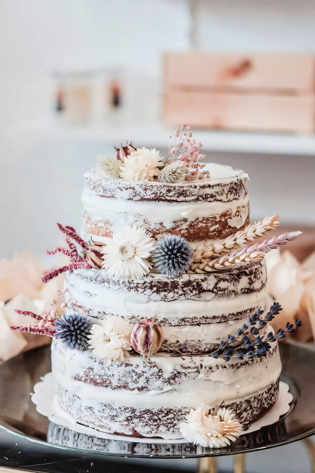 Naked boho wedding cake with exposed layers