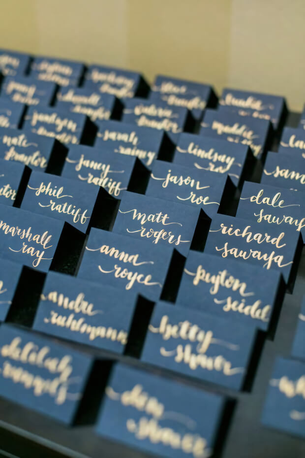 Navy and gold wedding seating cards with a starry allure
