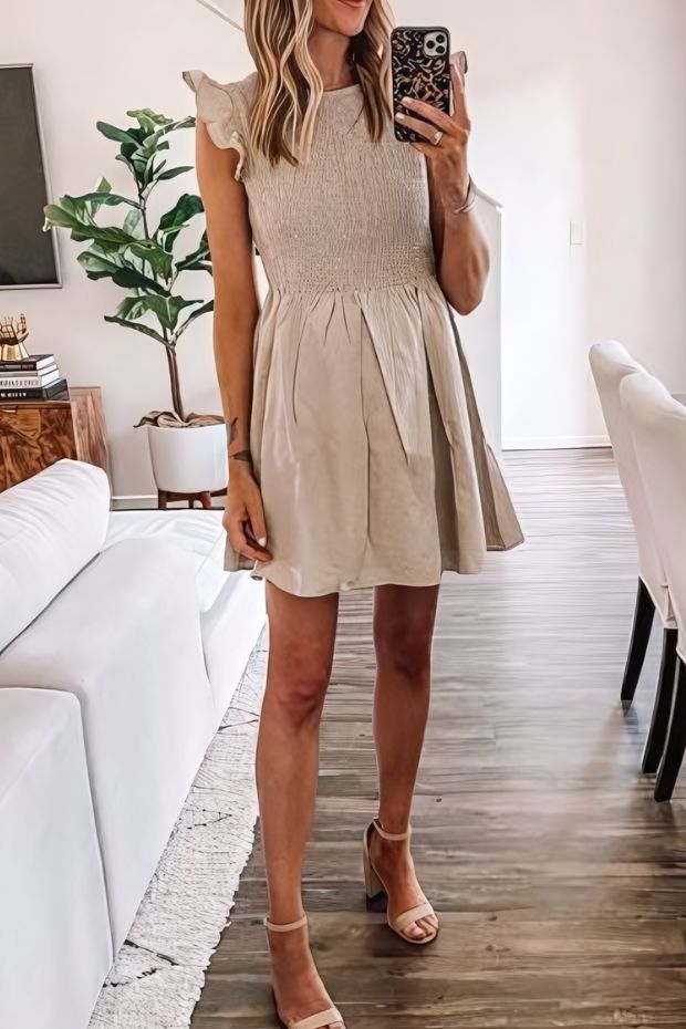 Neutral summer wedding guest look with A-line mini dress, block heels, and ruffle cap sleeves