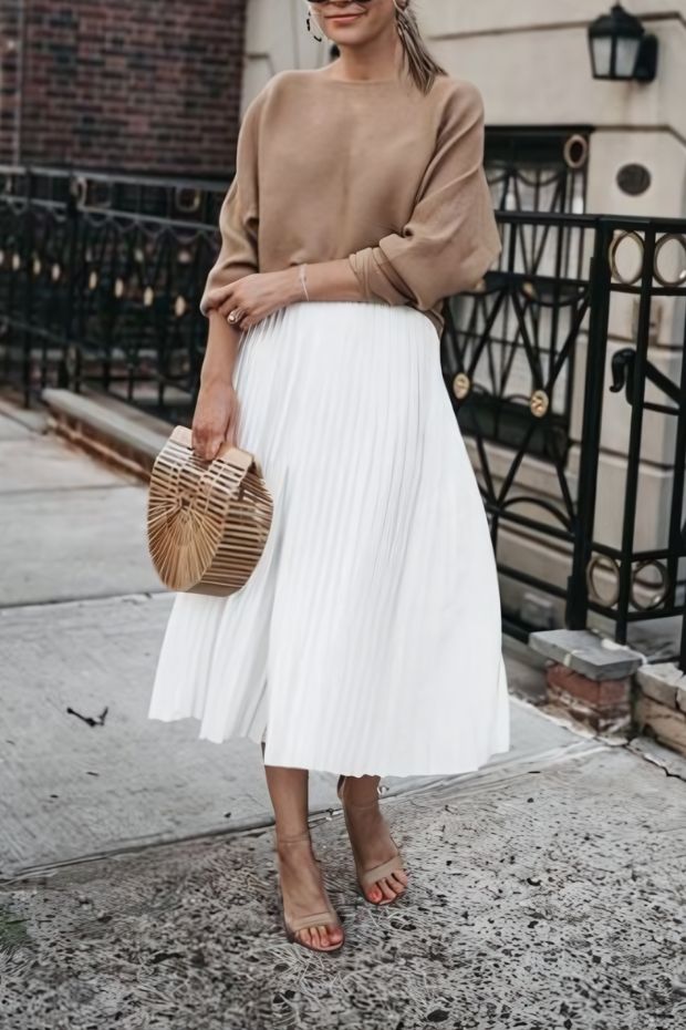 Striped shirt, yellow button-up midi skirt, white mules, and woven bag for a spring wedding