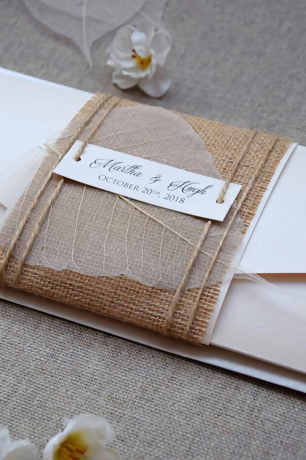 Burlap wedding invitation with white leaf design