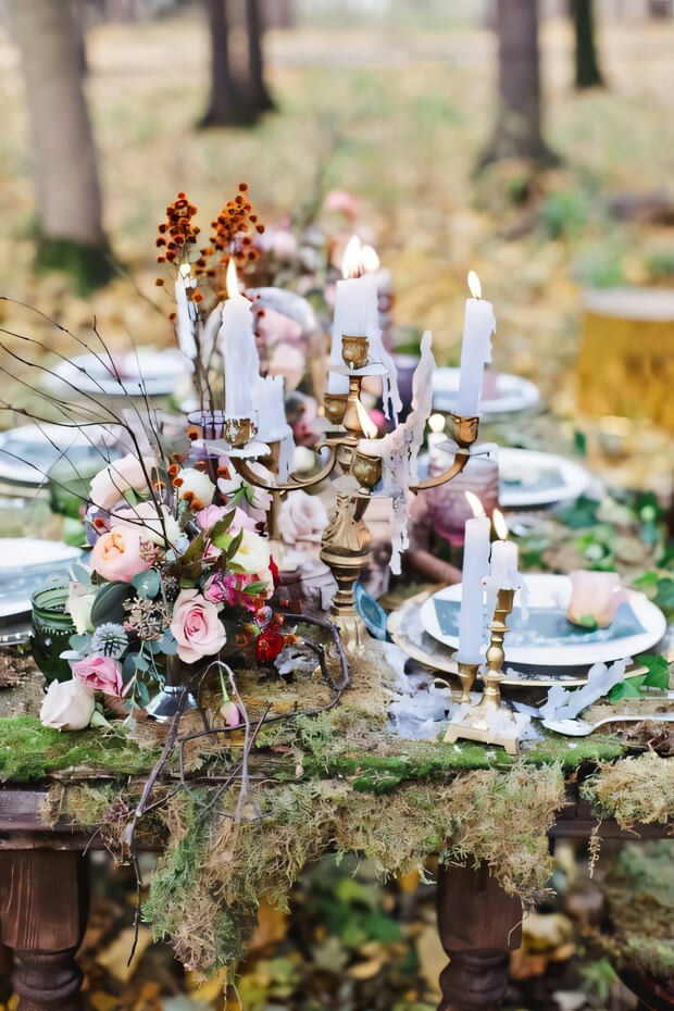 Chic fall enchanted forest wedding tablescape with moss runner, pink blooms