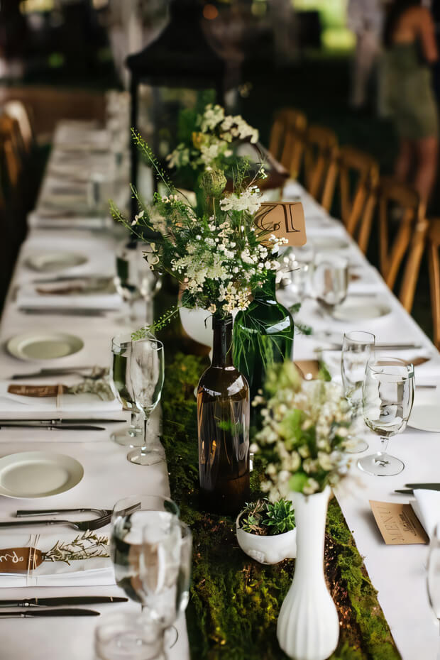 Enchanted forest wedding tablescape with moss table runner, potted succulents