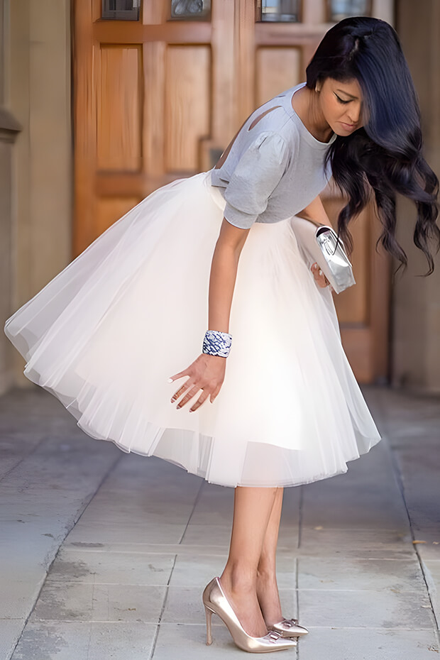 Holiday wedding guest outfit with grey jumper and white tutu skirt