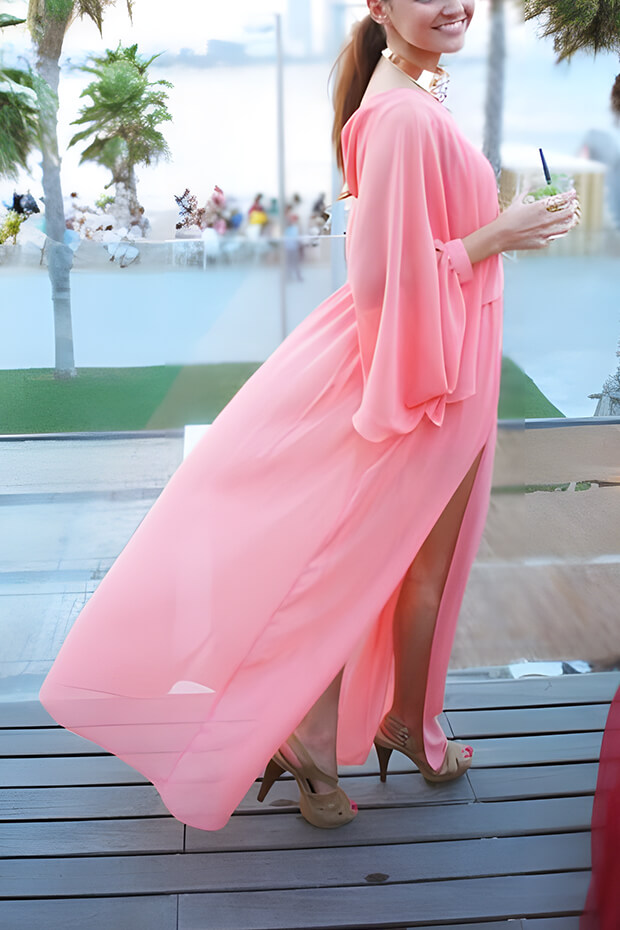 Light pink A-line maxi dress with long sleeves and statement necklace