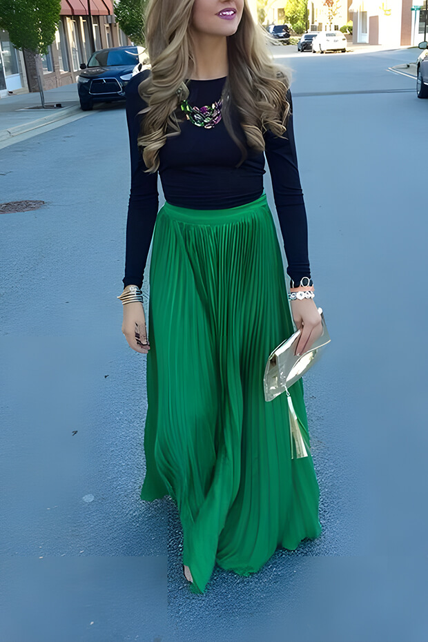 Stylish holiday wedding guest outfit with emerald pleated maxi skirt