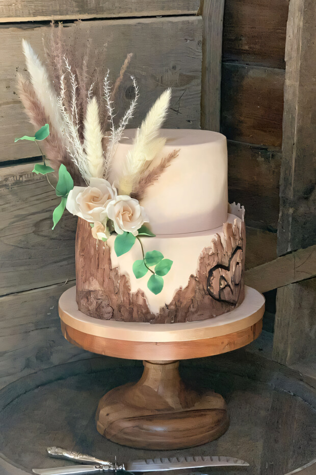 Two-tiered cake with pink and white flowers