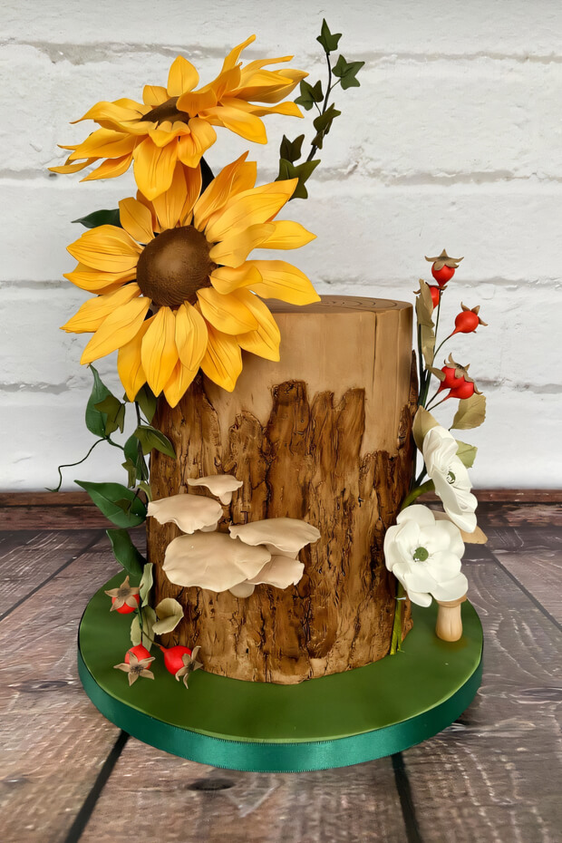 Tree stump cake with sunflowers and berries