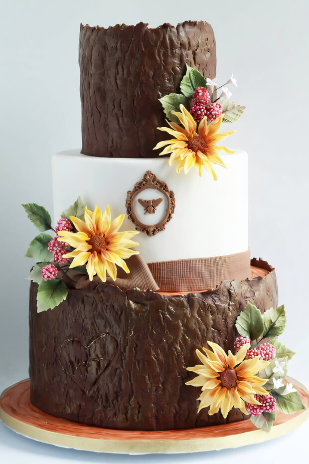 Tree stump cake with sunflowers and decorations